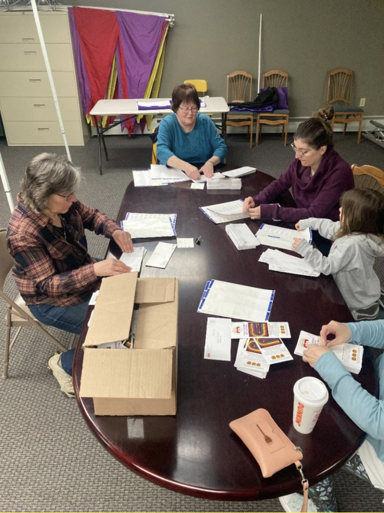 Colorscape volunteers help around a table